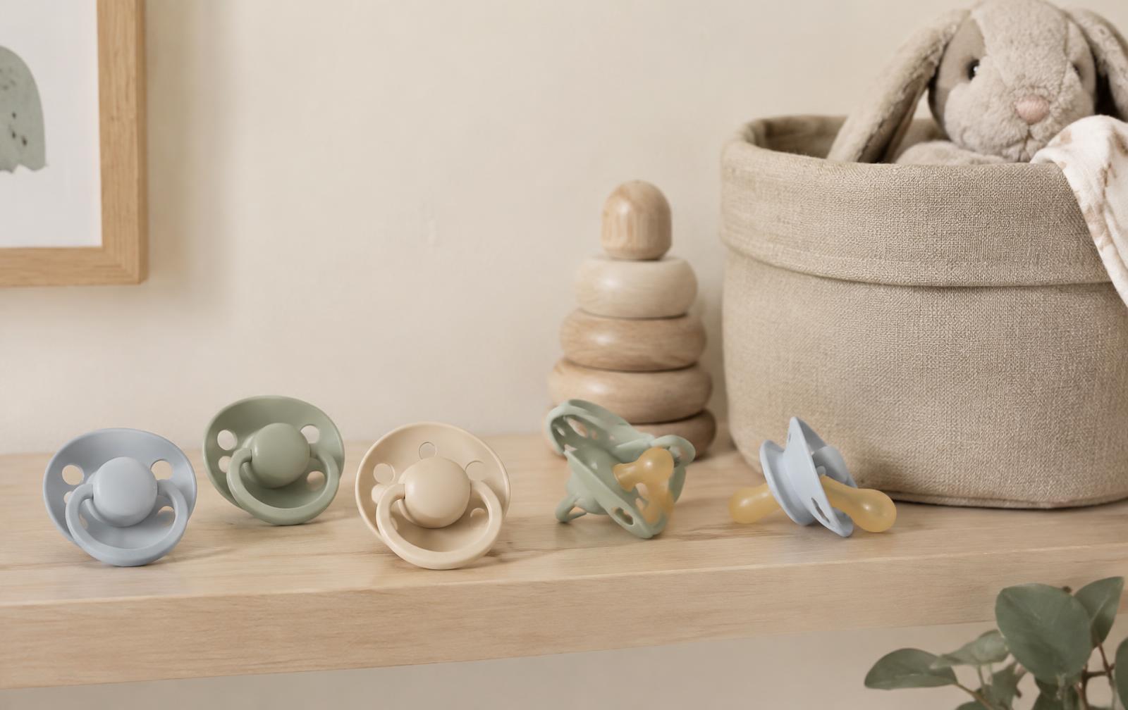 Pastel pacifiers arranged on a nursery shelf